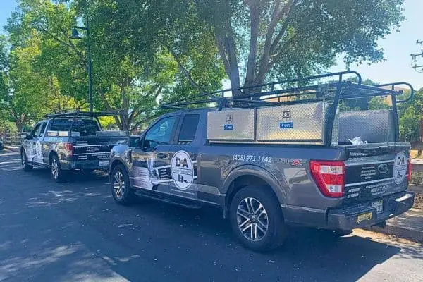 D&A Custom Painting work truck towing an equipment trailer